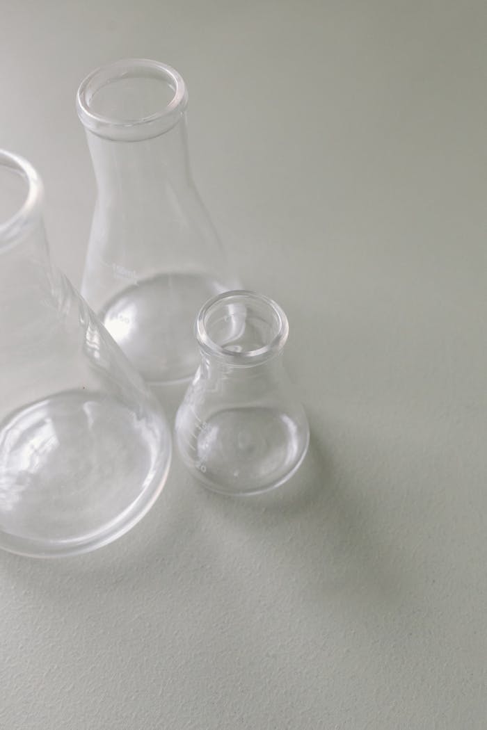 Clear Glass Bottle on White Table